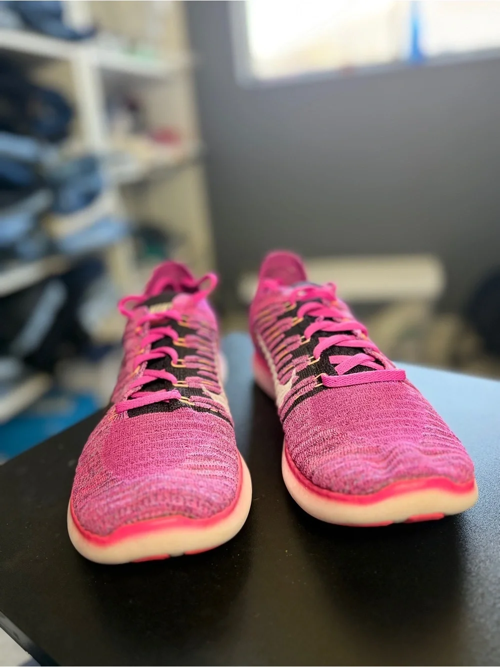 Nike Women's Pink Flyknit Running Sneakers with Black Swoosh